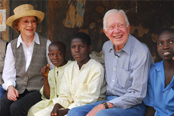 Photo of Rosalynn and Jimmy Carter with a child in Nigeria.