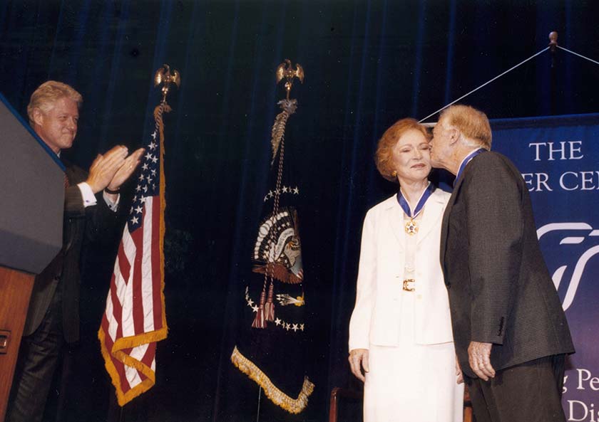 Photo of former President Jimmy Carter and former First Lady Rosalynn Carter with President Bill Clinton at the Presidential Medal of Freedom ceremony in 1999.