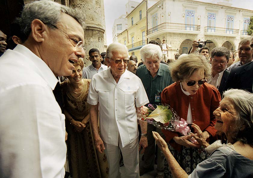 Rosalynn Carter receives flowers from a Cuban woman while touring Old Havana in May 2002.
