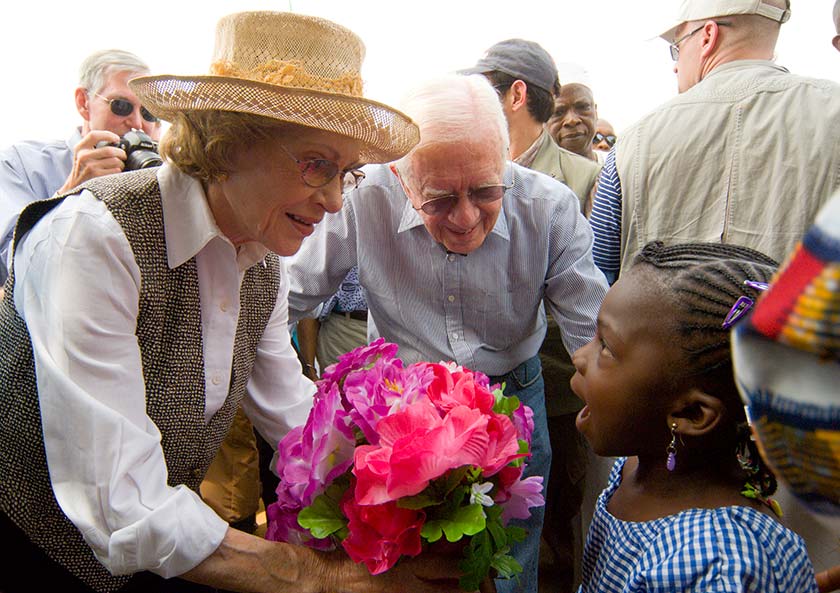 Rosalynn Carter received a bouquet of pink flowers from a young girl.