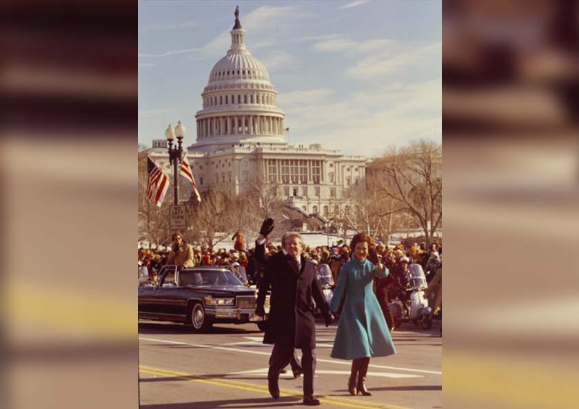 Photo of the Carters walking down Pennsylvania Avenue during the inaugural parade on Jan. 20, 1977.