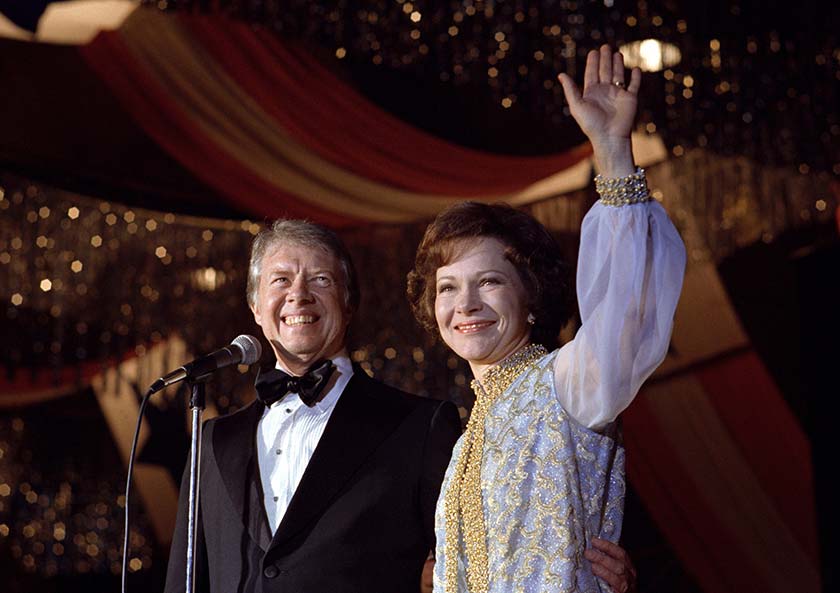 Photo of President Carter and First Lady Rosalynn Carter waving to inaugural ball guests.